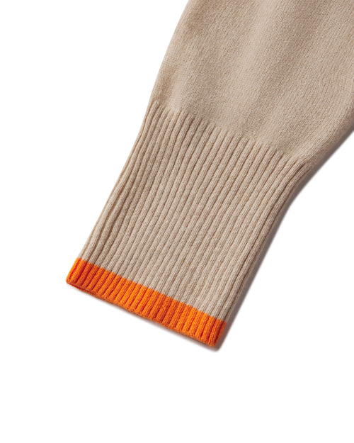 Close-up of oatmeal beige cashmere hoodie sleeve with ribbed cuff and orange edge detail