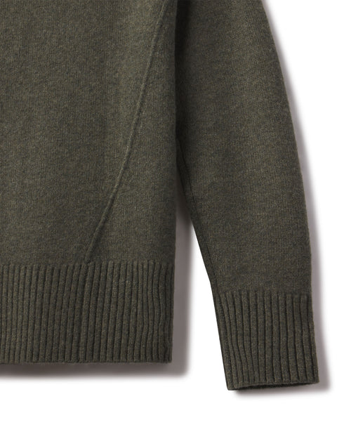Close-up of the dark olive cashmere funnel neck sweater sleeve and ribbed hem