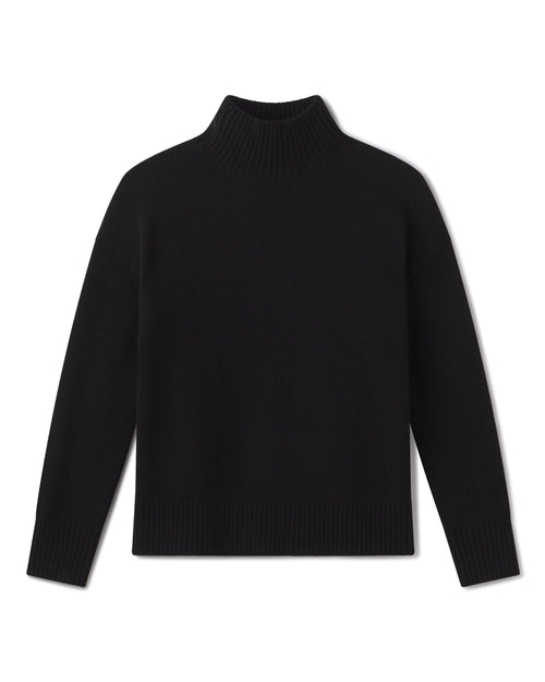 Black cashmere funnel neck sweater laid flat, showing the ribbed collar, cuffs and hem