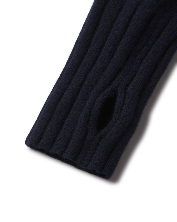 Close-up of navy blue ribbed cashmere sleeve with thumb hole detail