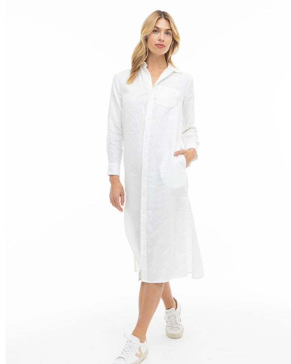 LIFESTYLE / EDITORIAL: Woman in white long shirt dress and sneakers standing against white background