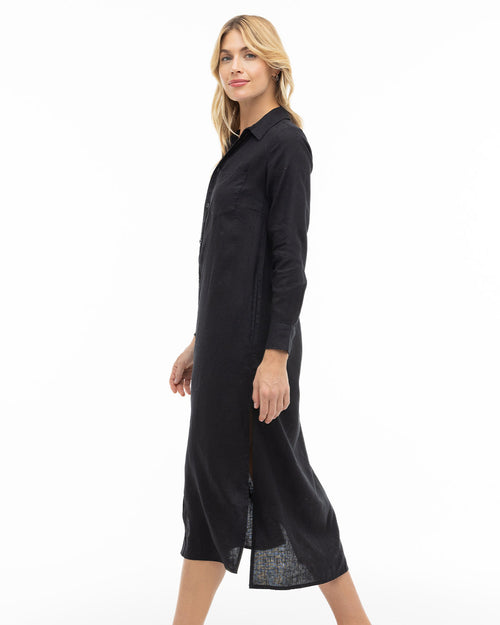 LIFESTYLE / EDITORIAL: Woman in black long-sleeve buttoned cashmere dress standing sideways on white background