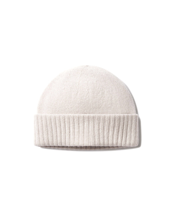Front view image of a cashmere knit hat in oatmeal with a folded ribbed brim on a white background