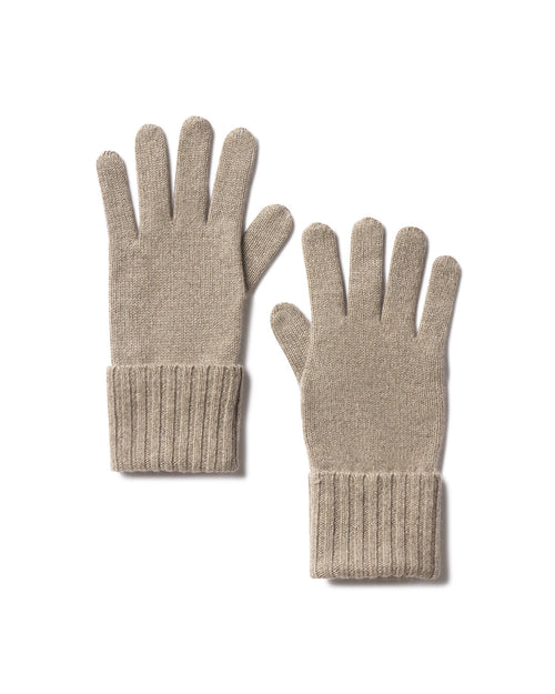 Pair of beige cashmere gloves with ribbed cuffs laid flat on white background