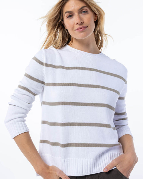 Front view image of a woman wearing a white cashmere sweater with mushroom horizontal stripes, hands relaxed by sides