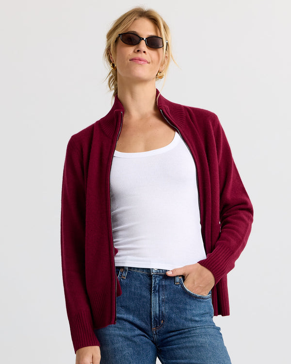 LIFESTYLE / EDITORIAL: Woman wearing barolo red zip-up cashmere cardigan over white tank and blue jeans, sunglasses on