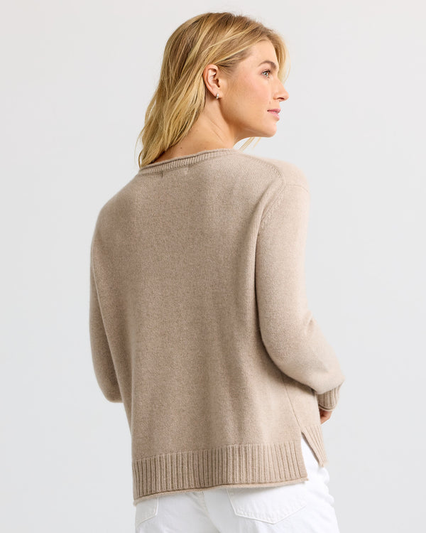 LIFESTYLE / EDITORIAL: Woman wearing cappuccino-colored cashmere sweater, shown from back and side profile