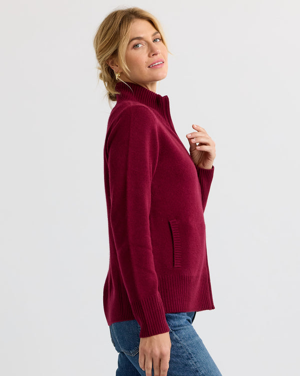 Woman in side profile wearing a barolo red cashmere sweater with front pockets and ribbed cuffs and hem