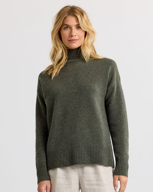Dark olive cashmere funnel neck sweater with light trousers, front view
