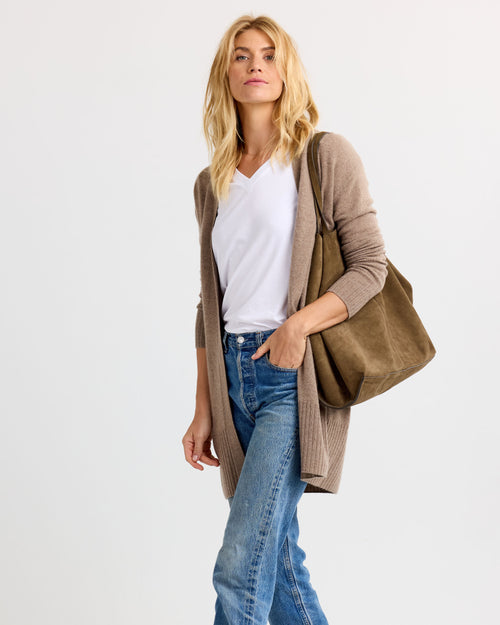 LIFESTYLE / EDITORIAL: Woman wearing white tee, driftwood-colored long cardigan, blue jeans, and carrying a matching tote bag