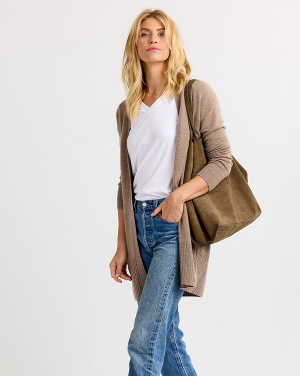 LIFESTYLE / EDITORIAL: Woman wearing white tee, driftwood-colored long cardigan, blue jeans, and carrying a matching tote bag