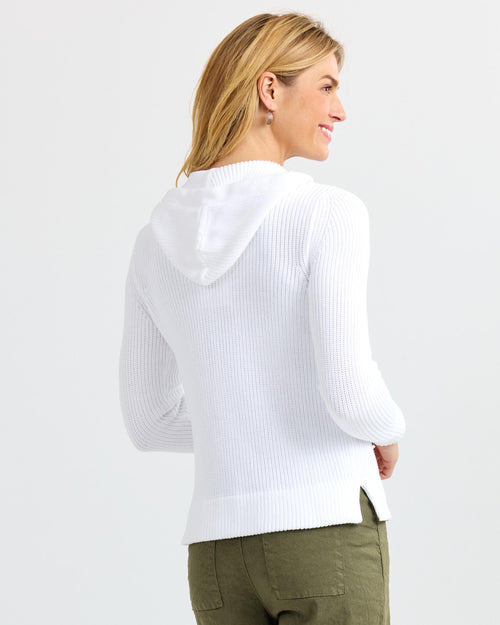 LIFESTYLE / EDITORIAL: Woman wearing white ribbed cashmere hoodie and olive pants, shown from back and side profile