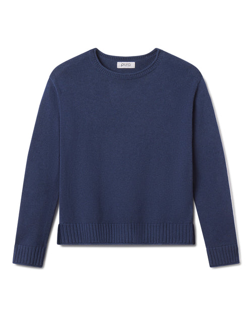 Cashmere crewneck sweater in midnight blue with ribbed cuffs and hem, laid flat on white background