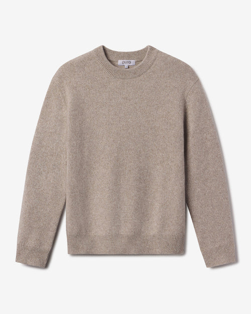 Men's beige crew neck cashmere sweater laid flat, long sleeves, ribbed cuffs and hem, plain knit texture