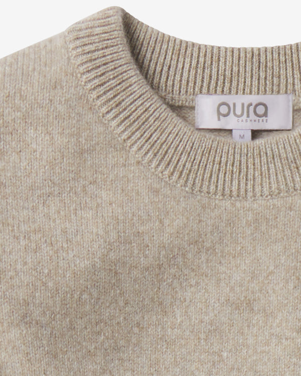 Close-up of beige cashmere crew neck sweater with "pura cashmere" label in size medium