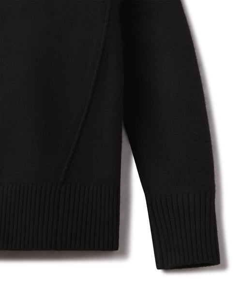 Close-up of the black cashmere funnel neck sweater sleeve and ribbed hem