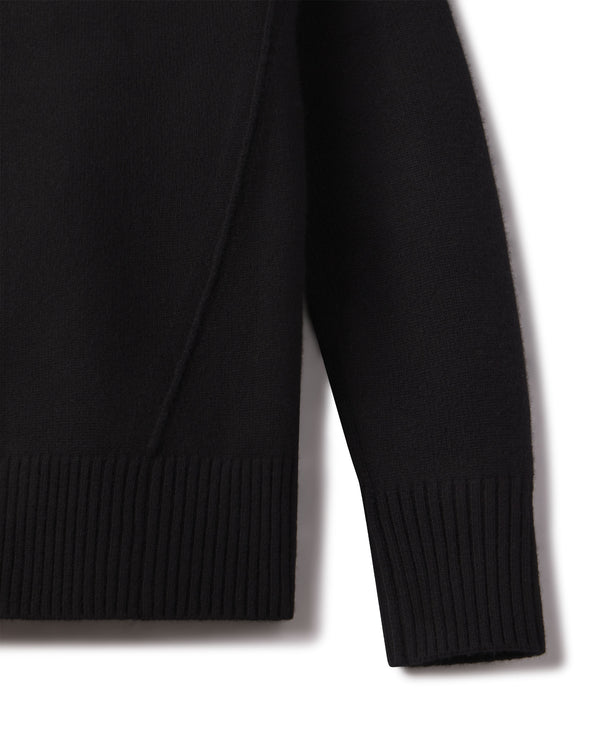 Close-up of the black cashmere funnel neck sweater sleeve and ribbed hem