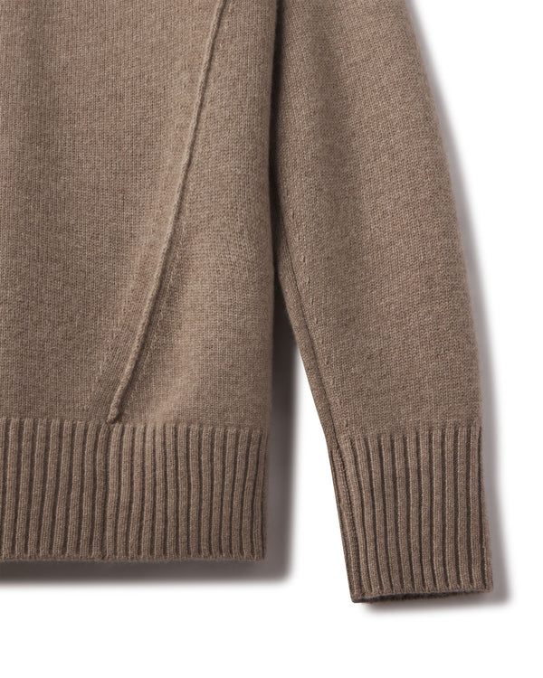 Close-up of the driftwood cashmere funnel neck sweater sleeve and ribbed hem