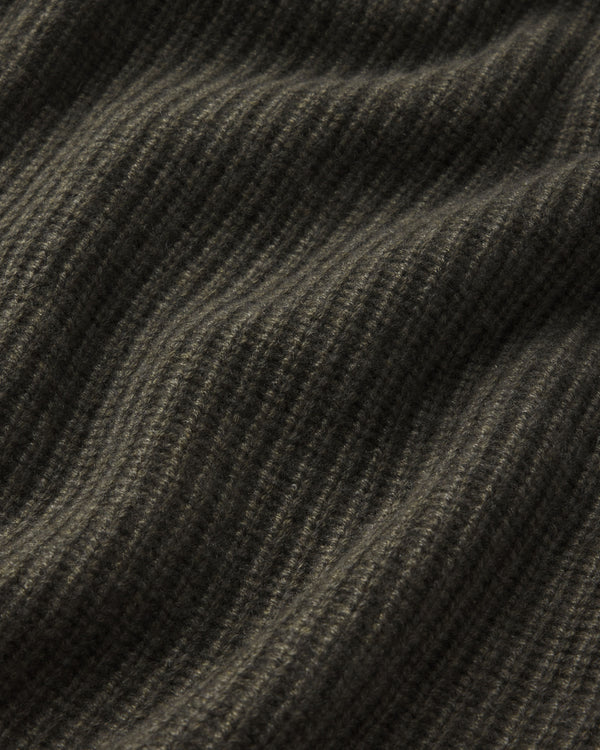 Close-up of dark olive ribbed cashmere fabric texture with soft folds