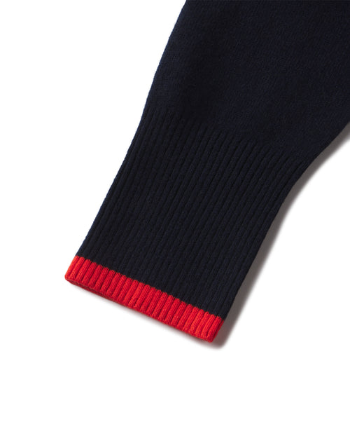 Close-up of navy cashmere sleeve cuff with red ribbed contrast edge on hoodie