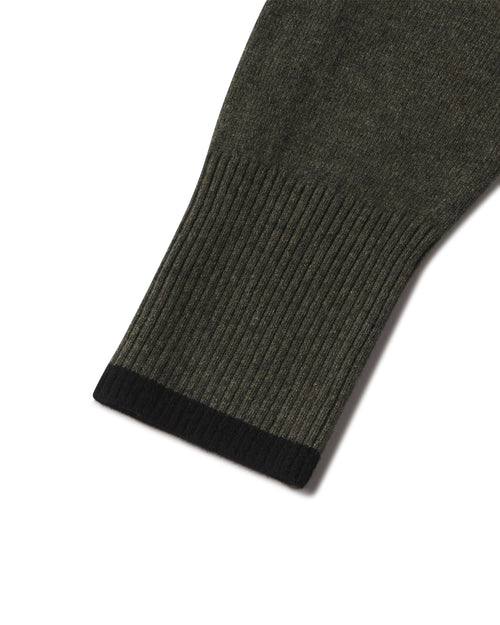 Close-up detail image of a cashmere hoodie sleeve in dark olive with black ribbed cuff contrast