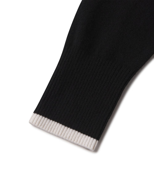 Close-up of black cashmere sleeve cuff with ivory ribbed edge on a hoodie