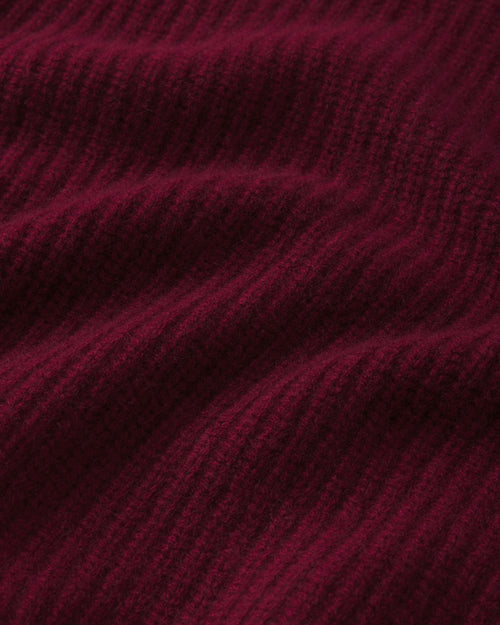 Close-up of ribbed cashmere fabric in deep barolo red color