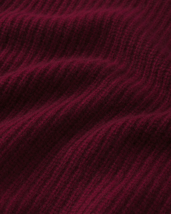 Close-up of ribbed cashmere fabric in deep barolo red color