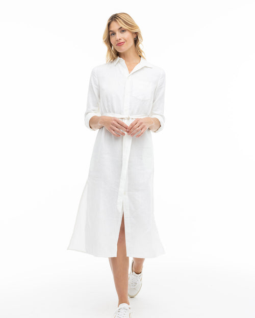 LIFESTYLE / EDITORIAL: Woman wearing a white button-down midi dress with sneakers on a white background