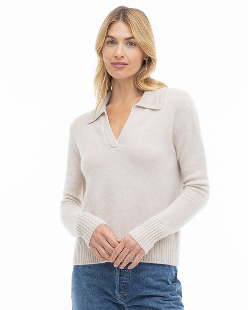 Front-facing image of a woman wearing an oatmeal cashmere sweater with collar and blue jeans against white background, shot 2