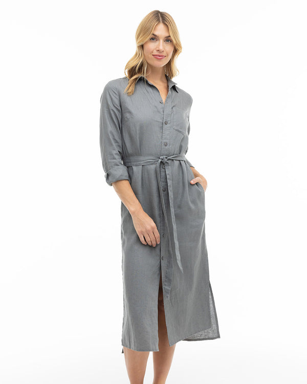 LIFESTYLE / EDITORIAL: Woman wearing a graphite gray buttoned midi dress with a waist tie, standing against white background