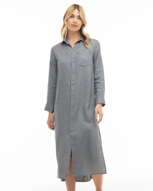 LIFESTYLE / EDITORIAL: Woman wearing long gray button-up shirt dress standing against white background