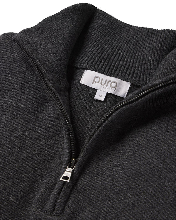 Close-up of dark gray cashmere quarter-zip sweater with visible zipper and Pura Cashmere label size M