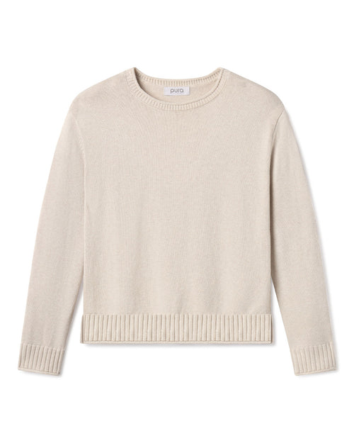 Cashmere crewneck sweater in oatmeal color with ribbed cuffs and hem, laid flat on white background