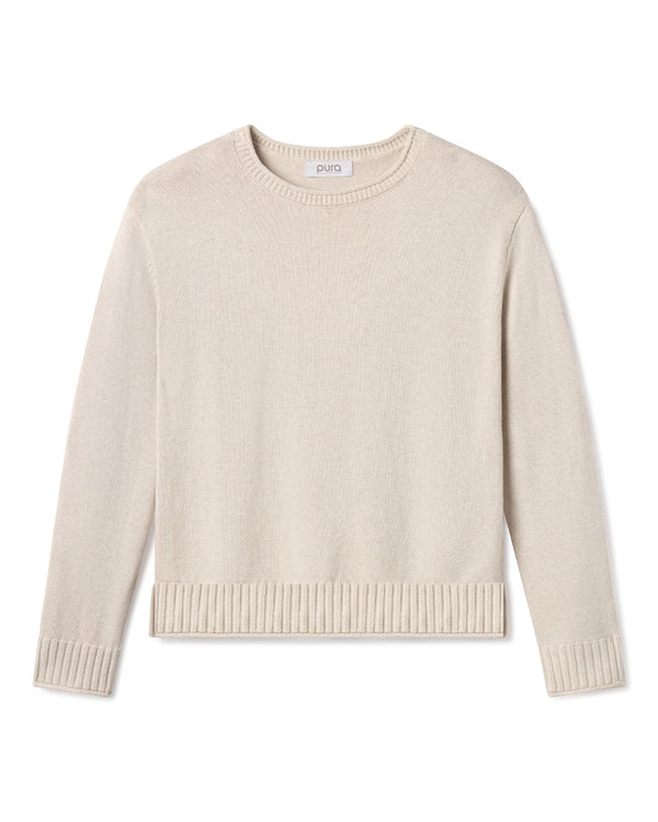 Cashmere crewneck sweater in oatmeal color with ribbed cuffs and hem, laid flat on white background