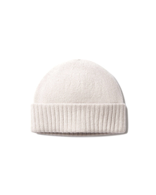 Front view image of a cashmere knit hat in oatmeal with a folded ribbed brim on a white background