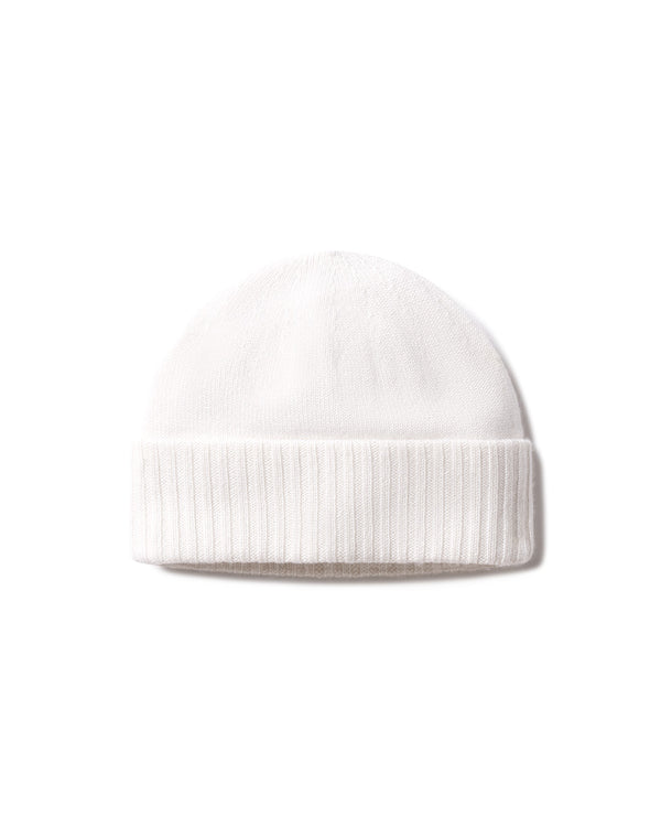 Ivory-colored cashmere knit hat with folded ribbed cuff, isolated on white background