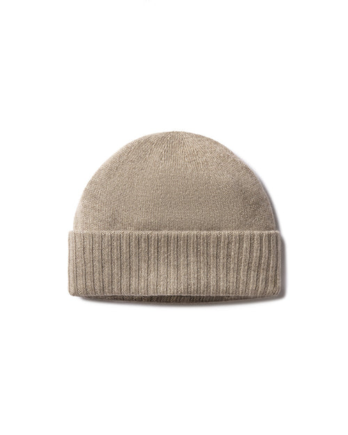 Cashmere knit hat in driftwood beige color with folded ribbed brim, isolated on white background
