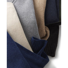 Close-up of folded cashmere sweaters in navy, beige, gray, camel, and black colors from Everyday Crew 3 collection